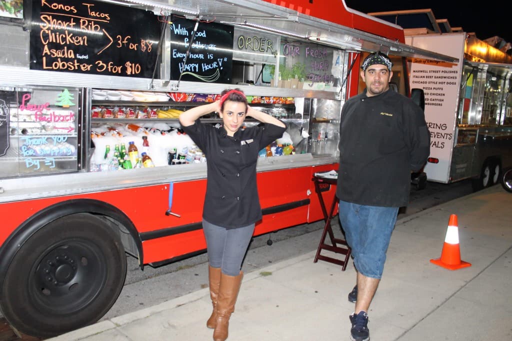 Nilani and Kachik in front of their red lunch truck